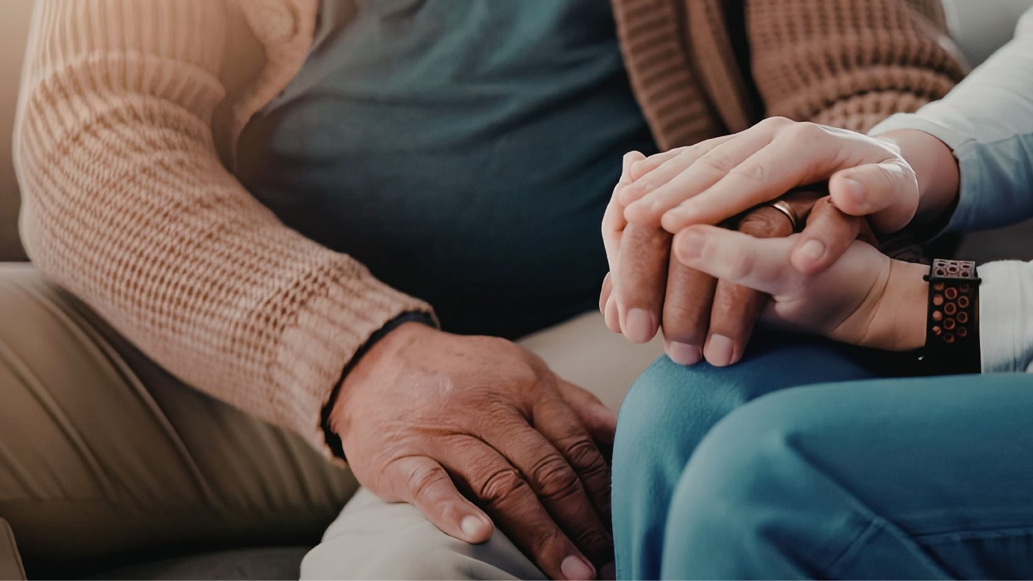 Family member holding the hand of a person living with chronic gout, offering comfort and support.